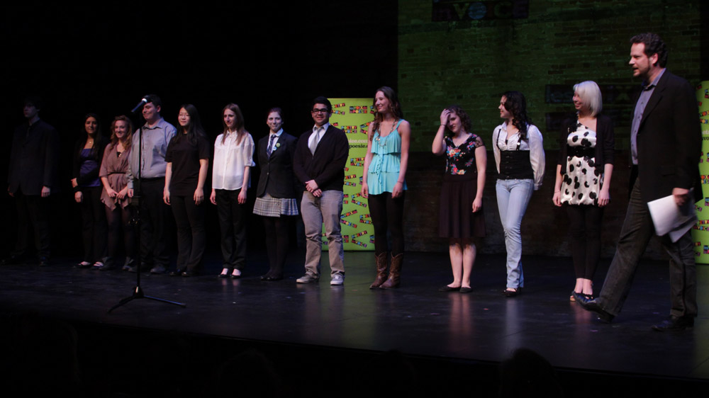 Albert Schultz introduces the competitors (left to right): Spencer Slaney of Lockerby Composite School in Sudbury, Ontario; Malvika Chowdry of Trafalgar Castle School in Whitby, Ontario; Brogan Carruthers of South Carleton High School in Richmond (Ottawa region), Ontario; Jonathan Welstead of Upper Canada College in Toronto; Anna Jiang of Victoria Park Collegiate Institute in North York, Ontario; Estera Musiala of R. H. King Academy in Scarborough, Ontario; Victoria Campbell of Toronto French School; David Castillo of London Central Secondary School in London, Ontario; Lily MacLeod of Lawrence Park Collegiate Institute in Toronto; Mélodie Cyr of Collège Notre-Dame in Sudbury, Ontario; Suzanna Alsayed of Cawthra Park Secondary School in Mississauga, Ontario; Amelia Druskis of Bayridge Secondary School in Kingston, Ontario; Albert Schultz.